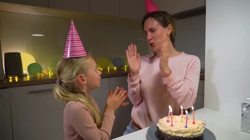 Mother and Child Celebrate Birthday with Cake and Joy