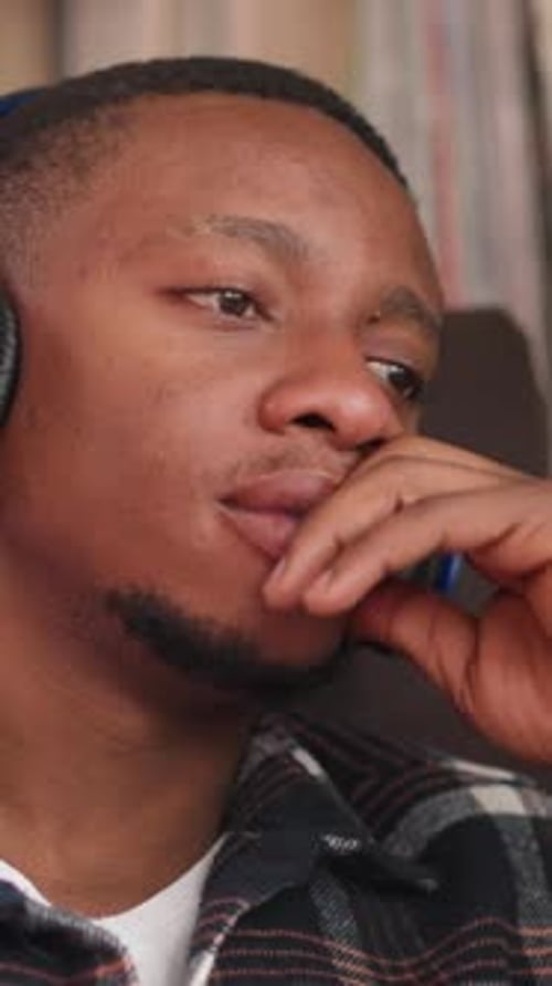 Upset Man Listens to Music Via Earphones