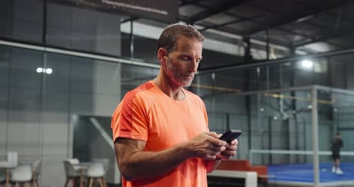 Texting, athlete and man with smartphone, court and sport updates on social media and communication