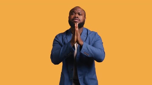 Man Clasping Hands in Prayerful Request