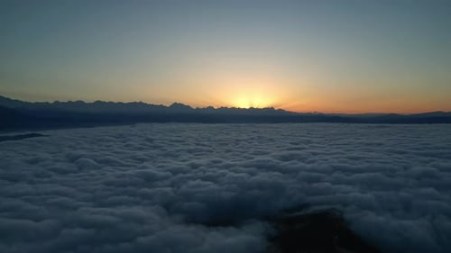 Breathtaking Sunrise Over Mountains and Clouds Aerial View