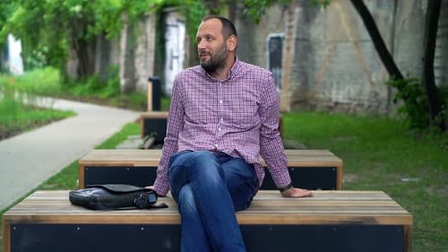 Young Man Relaxing in City Park