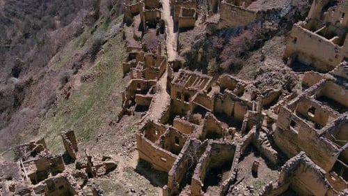 Medieval stone ruins of an old mountain village. archaeological heritage. Close up drone view of an