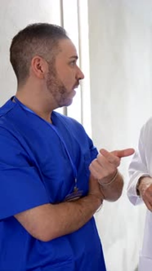 Medical team discussing patient treatment in hospital hallway