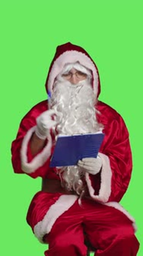 Vertical Video Front View of Man Santa Claus Write on Papers