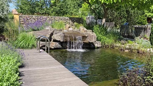 A small stream of water flows over a rock wall
