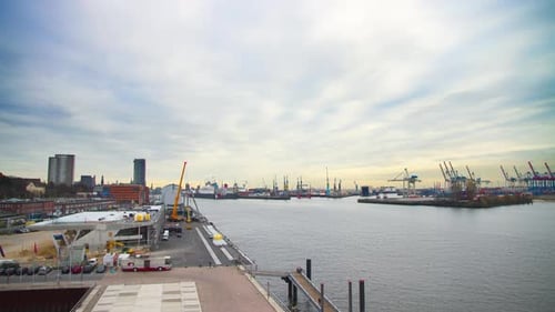 beautiful time lapse long shot of the port of Hamburg with many ships and a huge container ship