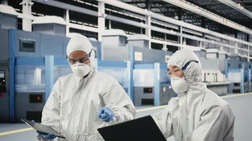 Engineering Team Working Together in Semiconductor Production Plant Floor