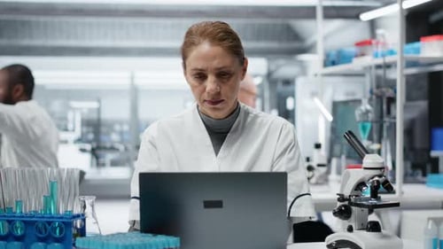 Scientist Working On Laptop Having a Headache