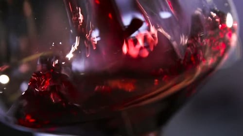 Pouring red wine into a glass, close up