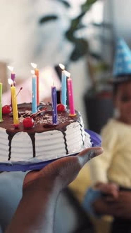 Family Celebrates Birthday with Cake and Candles