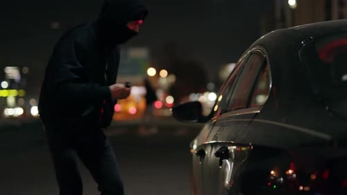 A Mesmerizing Nighttime Urban Scene Showcasing a Car Illuminated By Vibrant City Lights