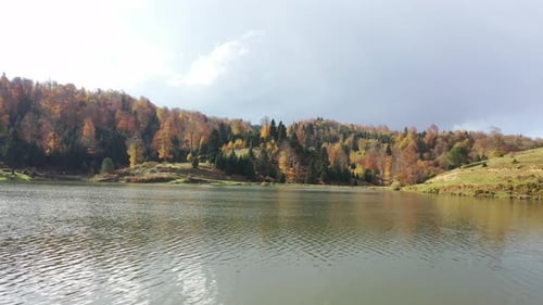 a lake in the forest and the autumn season