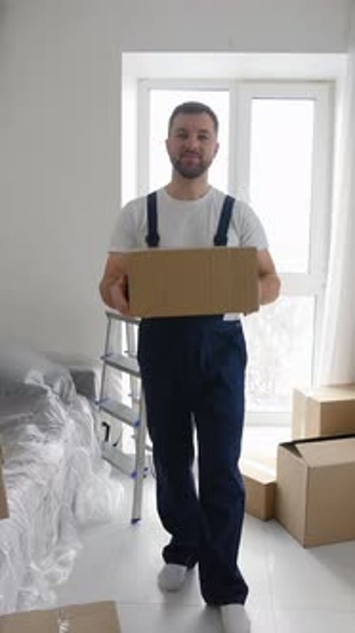 Man Carries Box in New Home