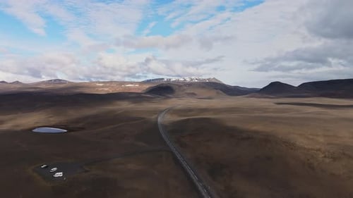 Winding Road Through Icelandic Hills Captured By Drone In Summer Light