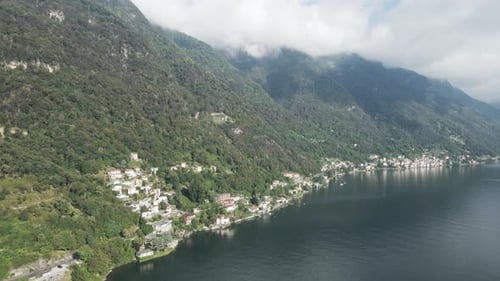 A drone shot panning across the shoreline of Lake Como in Italy.