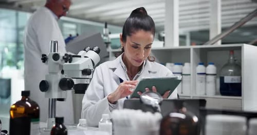 Woman Scientist Using Tablet in Bright Laboratory