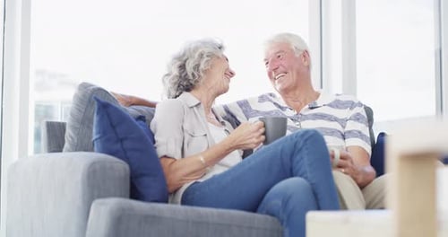 Smiling Senior Couple Relaxing Together on Couch