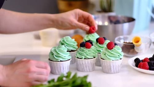 Cupcakes with green frosting and berries