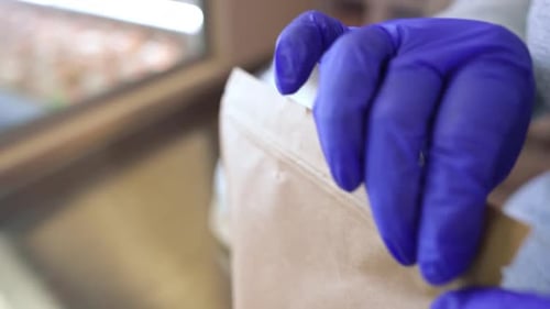 Closeup Hands Closing Food Delivery Bag in Slow Motion