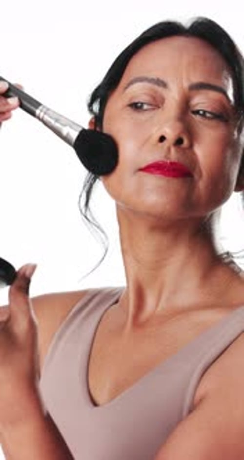 Mature woman, makeup brush and sequence in studio for beauty cosmetics on a white background