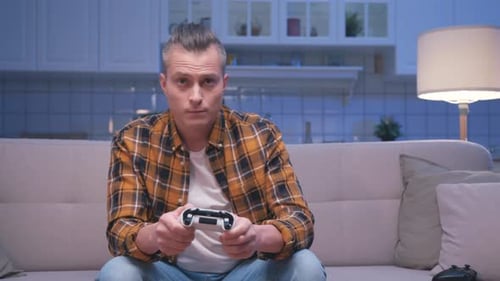 Young Adult Playing Video Game on Couch