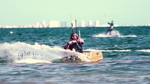 Sportsman practicing kite surf sport at the beach on a windy day at the Spanish coasts
