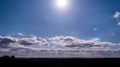 Timelapse of Cumulus Clouds Moving in the Sky with Sun Over the Horizon