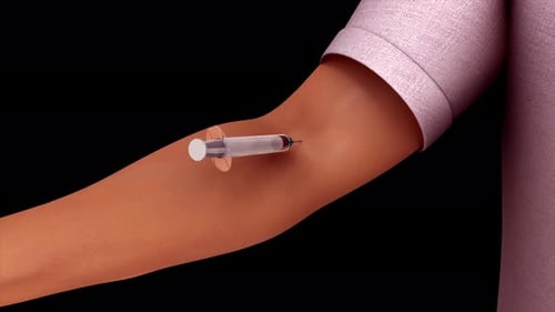 Eine Spritze wird in den Arm einer Person eingeführt