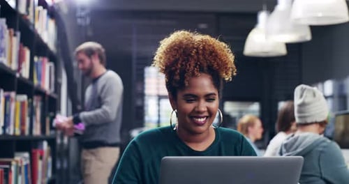 4k video of a student using her laptop in the college library