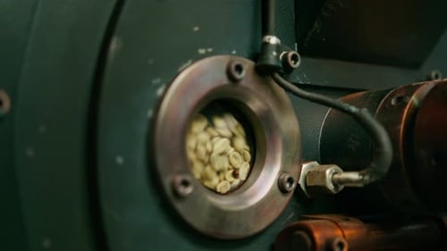Coffee beans are rotated in a machine for roasting coffee beans close-up of craft coffee production