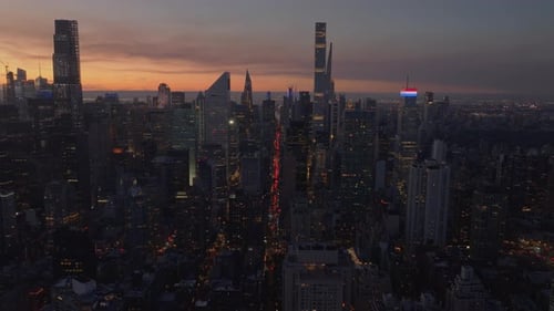 Midtown Manhattan and Setting Sun Bathing New York City Skyline in Warm Orange and Yellow Tones