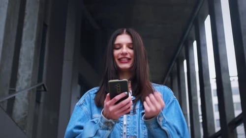 Portrait of Happy Business Woman Enjoy Success on Mobile Phone Outside Urban City Closeup Joyful