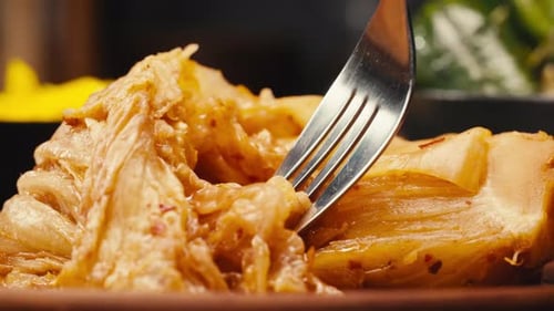 Taking a Little Bit of Fermented Spicy Cabbage Kimchi By Fork Closeup Preservation of Vegetables in