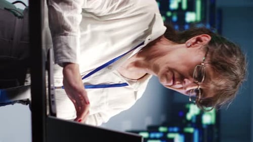 Woman Works at Computer in Office Environment