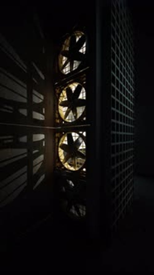 Ventilation System Creates Striking Shadows in a Dimly Lit Industrial Space