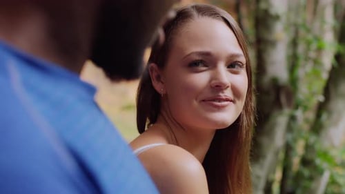Interracial Couple Talking Front of Small Waterfall in an Australian Rainforest Path