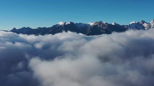 Aerial view of clouds and mountains at sunrise