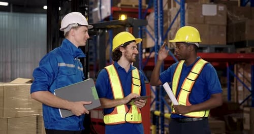three warehouse staff including african american and caucasian workers collaborating during shipment