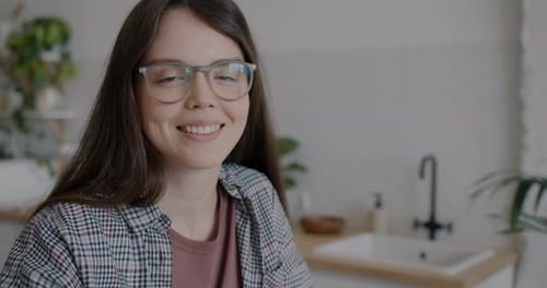Smiling Woman with Glasses at Home