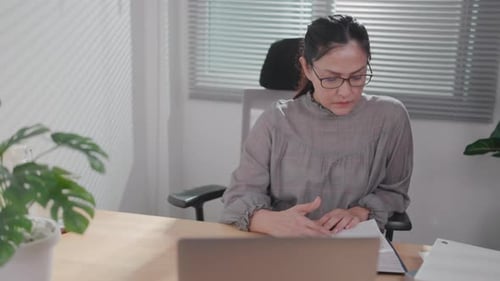 Close-up of a woman reading in the living room in search of stories, novels and blissful knowledge.
