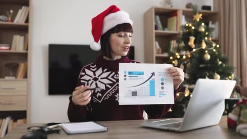 Woman in Santa Hat Presents Business Growth Data