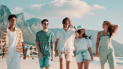 Friends, group and walking on beach for travel with bonding, conversation and wind for vacation