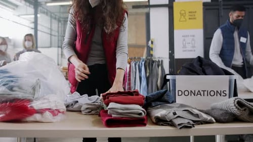 Volunteers Sort Clothing Donations at a Warehouse