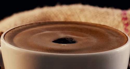 Coffee, drop and cup with ripple at cafe for strong caffeine, latte or cappuccino of French roast