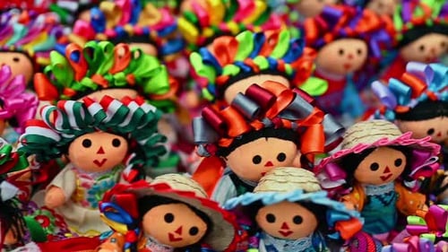 Colorful traditional Mexican rag handmade doll isolated in white. Doll with long braids and ribbons