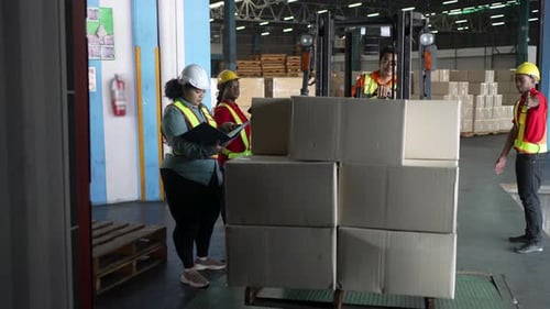 Blue collar workers working at warehouse.