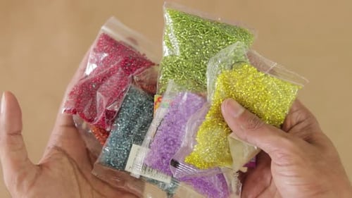 Small colored beads (chaquira) for crafts.