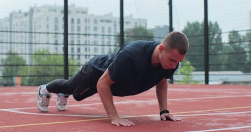 Man in Sportswear Doing Pushup Exercise on Basketball Court Healthy Lifestyle and Sport Concept