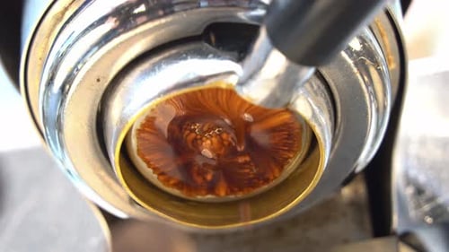 Low angle cinematic close up view capturing the channel from coffee extraction, specialty single ori